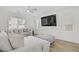 Bright living room with large television, plush seating, and a modern ceiling fan at 4436 Mural Glen Ct, North Las Vegas, NV 89084