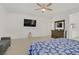 The main bedroom features a ceiling fan, a large television, and a vanity at 4436 Mural Glen Ct, North Las Vegas, NV 89084