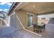 Covered patio featuring brick pavers and an outdoor dining set with comfortable seating at 4436 Mural Glen Ct, North Las Vegas, NV 89084