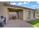 Covered patio with brick pavers, an outdoor dining set, and a barbecue grill nearby at 4436 Mural Glen Ct, North Las Vegas, NV 89084