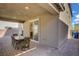 Covered patio featuring brick pavers, an outdoor dining set, and a view of the backyard at 4436 Mural Glen Ct, North Las Vegas, NV 89084