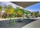 Neighborhood playground featuring swings under a shade canopy for enjoyable outdoor activities at 4436 Mural Glen Ct, North Las Vegas, NV 89084