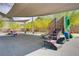 Well-maintained playground with slides, stairs, and shaded seating area for community enjoyment at 4436 Mural Glen Ct, North Las Vegas, NV 89084