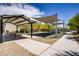 Community playground with shade structures, picnic tables, and benches, perfect for outdoor gatherings at 4436 Mural Glen Ct, North Las Vegas, NV 89084