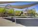 Community playground with climbing features and protective shade canopy for outdoor fun at 4436 Mural Glen Ct, North Las Vegas, NV 89084