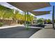Community playground featuring shade canopies, a merry-go-round, and swings for outdoor fun at 4436 Mural Glen Ct, North Las Vegas, NV 89084