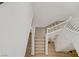 Overhead shot of carpeted staircase with white banisters and wood landing at 4436 Mural Glen Ct, North Las Vegas, NV 89084