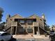 Exterior view of an attractive multi-unit home featuring a light brown facade and ample parking at 4670 Tracylynn Ln, Las Vegas, NV 89121