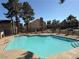 Sparkling blue pool surrounded by a secure fence and mature trees in a community setting at 4670 Tracylynn Ln, Las Vegas, NV 89121