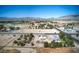 Wide aerial panorama captures a home, detached garage, expansive neighborhood, and distant mountains on a clear day at 481 Jarvis Rd, Pahrump, NV 89060
