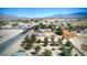 Panoramic aerial shot showcasing a home, detached garage, and the picturesque town against the backdrop of majestic mountains at 481 Jarvis Rd, Pahrump, NV 89060