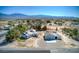 Aerial view of a desert community featuring the house with an extended garage and mountain views at 481 Jarvis Rd, Pahrump, NV 89060