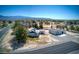 Aerial view of the property showcasing house, large garage, and desert landscaping with mountain views at 481 Jarvis Rd, Pahrump, NV 89060