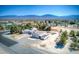 Expansive aerial view of a charming home, detached garage, and beautiful mountain backdrop in a serene neighborhood at 481 Jarvis Rd, Pahrump, NV 89060