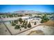 Scenic aerial view highlighting a home, detached garage, spacious yard, and stunning mountain views in a peaceful neighborhood at 481 Jarvis Rd, Pahrump, NV 89060