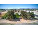 Landscaped property with a house, bordered by trees and foliage, surrounded by a desert landscape at 481 Jarvis Rd, Pahrump, NV 89060