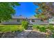 Charming home exterior with a walkway, lush greenery and a well maintained yard at 481 Jarvis Rd, Pahrump, NV 89060