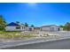 Property view with a house, oversized garage, and desert landscaping under a bright blue sky at 481 Jarvis Rd, Pahrump, NV 89060