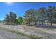 Scenic front yard features mature trees, concrete fence posts and gravel landscaping at 481 Jarvis Rd, Pahrump, NV 89060