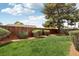 Well-maintained backyard featuring a lush lawn and a sturdy wooden fence for privacy at 4813 Canadian Dr, Las Vegas, NV 89130