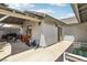 A covered backyard patio area includes a grill and comfortable outdoor seating at 4813 Canadian Dr, Las Vegas, NV 89130