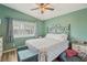 Well-lit bedroom with ceiling fan and window is cozy and inviting for relaxation at 4813 Canadian Dr, Las Vegas, NV 89130