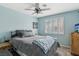 Relaxing bedroom with a ceiling fan and shuttered windows offers a serene and comfortable space at 4813 Canadian Dr, Las Vegas, NV 89130