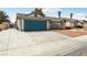 Inviting single-story home with a well-maintained lawn, desert landscaping, and a blue garage door at 4813 Canadian Dr, Las Vegas, NV 89130
