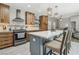 Stylish kitchen boasts an island with seating, modern appliances, and an open design ideal for entertaining at 4813 Canadian Dr, Las Vegas, NV 89130