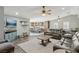 Open-concept living room with modern furnishings, ceiling fans, and views of the kitchen at 4813 Canadian Dr, Las Vegas, NV 89130