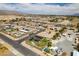 Wide aerial shot displays the neighborhood and the property's backyard pool and putting green at 5120 Lone View Pl, Las Vegas, NV 89149