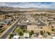 Aerial view of the house with a putting green and pool in a desert neighborhood at 5120 Lone View Pl, Las Vegas, NV 89149