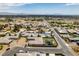 An aerial shot of a house, putting green, pool, and desert landscape at 5120 Lone View Pl, Las Vegas, NV 89149