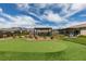 Expansive backyard with a lush lawn, putting green and mature landscape at 5120 Lone View Pl, Las Vegas, NV 89149