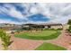Expansive backyard with a lush lawn, putting green and mature landscape at 5120 Lone View Pl, Las Vegas, NV 89149
