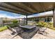 Backyard with a brick patio and fire pit under a pergola for outdoor entertaining at 5120 Lone View Pl, Las Vegas, NV 89149