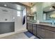 Modern bathroom featuring a walk-in shower and double vanity with gray cabinets at 5120 Lone View Pl, Las Vegas, NV 89149