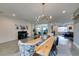 Well-lit dining room with a modern chandelier and long wood table, inviting atmosphere at 5120 Lone View Pl, Las Vegas, NV 89149