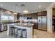 Stylish kitchen featuring a large island with seating, stainless steel appliances, and dark cabinetry at 5120 Lone View Pl, Las Vegas, NV 89149