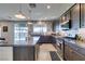 Open kitchen with granite countertops, stainless steel appliances, dark cabinets, and a view of the backyard at 5120 Lone View Pl, Las Vegas, NV 89149