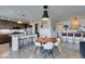 Modern kitchen with a center island, stainless steel appliances, bar stool seating, and easy access to living spaces at 5120 Lone View Pl, Las Vegas, NV 89149