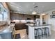 Modern kitchen with dark cabinets, gray countertops, island with seating, and stainless steel appliances at 5120 Lone View Pl, Las Vegas, NV 89149