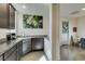 Well-lit kitchen area with granite countertops, stainless steel appliances, and open layout to dining area at 5120 Lone View Pl, Las Vegas, NV 89149