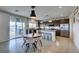 Open kitchen featuring stainless steel appliances, a center island with bar stools, and access to the backyard through sliding doors at 5120 Lone View Pl, Las Vegas, NV 89149