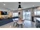 Open-concept living room and kitchen area with backyard access, ample natural light, and a comfortable seating arrangement at 5120 Lone View Pl, Las Vegas, NV 89149