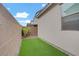 Cozy backyard featuring low-maintenance turf and neutral-toned perimeter walls for added privacy at 525 Monarch Ridge Ct, North Las Vegas, NV 89084
