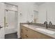 Bathroom with double sink vanity, modern fixtures, and a shower-tub combo at 525 Monarch Ridge Ct, North Las Vegas, NV 89084