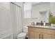 Bathroom featuring a shower-tub combo, white tiling, modern vanity, and neutral color palette at 525 Monarch Ridge Ct, North Las Vegas, NV 89084