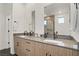Elegant bathroom features double sinks, sleek mirrors, and contemporary fixtures with natural wood cabinets at 525 Monarch Ridge Ct, North Las Vegas, NV 89084