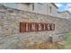 Stylish stone community sign for Indigo, set against an attractive brick wall at 525 Monarch Ridge Ct, North Las Vegas, NV 89084